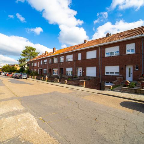 Het brede deel van de Voetbalstraat voor de werken. In het wegdek zitten er verschillende scheuren en putten.